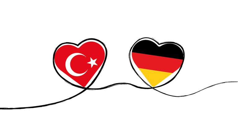 Zwei Herzen: Eines mit der türkischen Flagge und eines mit der deutschen schweben durch den Raum.